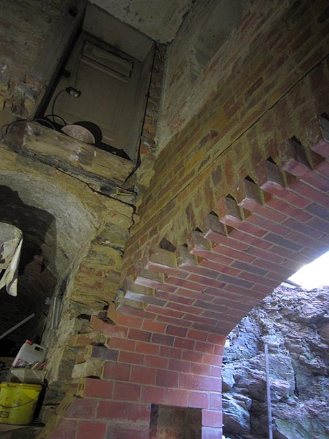 Готовая арка, заложенная кирпичём полностью до стыка со старой стеной.